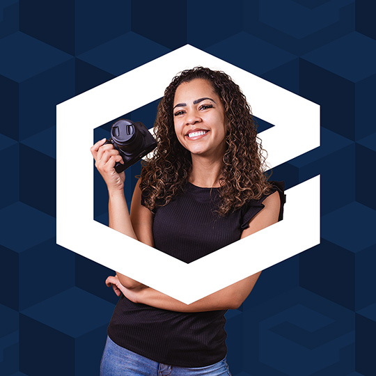 Female Creative standing in enigma logo